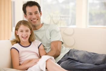 Royalty Free Photo of a Man on the Couch With His Daughter