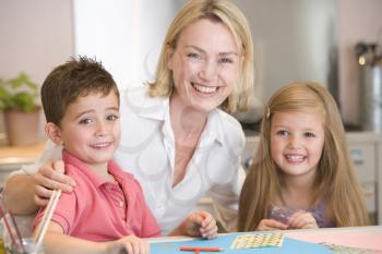 Royalty Free Photo of a Woman and Two Children Doing Art