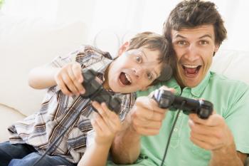 Royalty Free Photo of a Man and His Son Playing Video Games