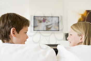 Royalty Free Photo of a Boy and Girl Watching TV