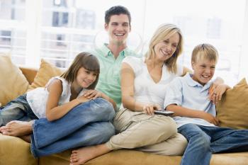 Royalty Free Photo of a Family With a Remote Control