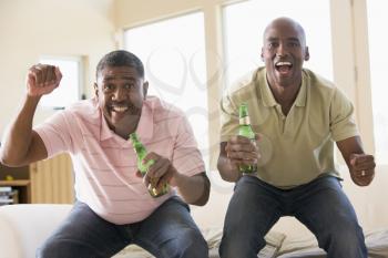 Royalty Free Photo of Two Men Cheering With Beer