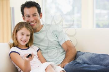 Royalty Free Photo of a Father and Daughter With a Remote