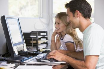 Royalty Free Photo of a Man and Daughter at the Computer
