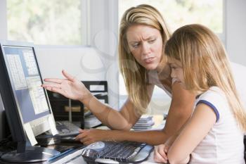 Royalty Free Photo of a Mother Upset With Her Daughter at the Computer