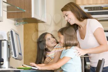 Royalty Free Photo of a Woman With Two Girls at a Computer