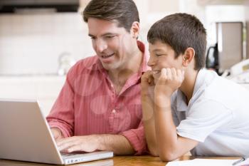 Royalty Free Photo of a Man and Boy at a Laptop