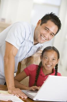 Royalty Free Photo of a Man and Daughter at a Laptop