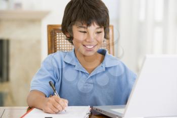 Royalty Free Photo of a Boy at Home With a Laptop