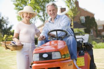 Royalty Free Photo of a Couple With a Lawn Mower
