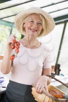 Royalty Free Photo of a Woman Holding Cherry Tomatoes