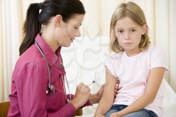 Royalty Free Photo of a Little Girl Getting a Needle