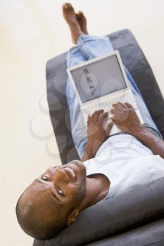 Royalty Free Photo of a Man in a Chair With a Laptop