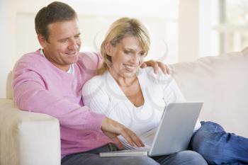 Royalty Free Photo of a Couple on a Couch With a Laptop