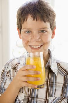 Royalty Free Photo of a Boy With a Glass of Orange Juice