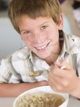 Royalty Free Photo of a Boy Eating Soup