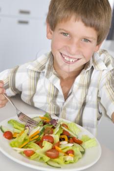 Royalty Free Photo of a Boy Eating a Salad