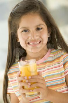 Royalty Free Photo of a Girl Drinking Orange Juice