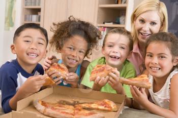 Royalty Free Photo of Four Children Eating Pizza