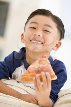 Royalty Free Photo of a Boy Eating Pizza