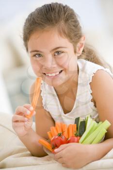 Royalty Free Photo of a Girl Eating Vegetables