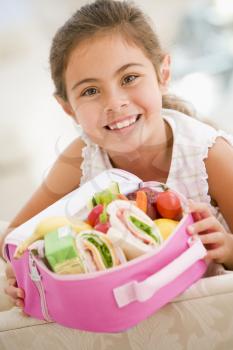 Royalty Free Photo of a Girl With a Lunchbox