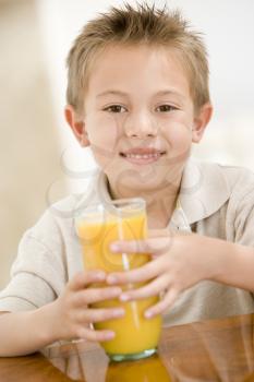 Royalty Free Photo of a Boy Drinking Orange Juice