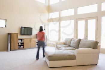 Royalty Free Photo of a Woman Walking in a Living Room