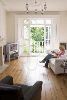 Royalty Free Photo of a Woman in a Living Room Watching Television