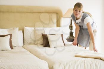 Royalty Free Photo of a Woman Making a Bed
