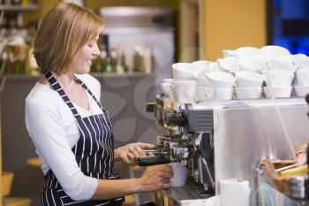 Royalty Free Photo of a Woman Making Coffee