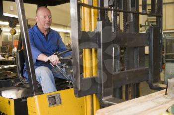 Royalty Free Photo of a Man in a Forklift