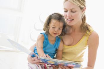 Royalty Free Photo of a Woman Reading to Her Daughter