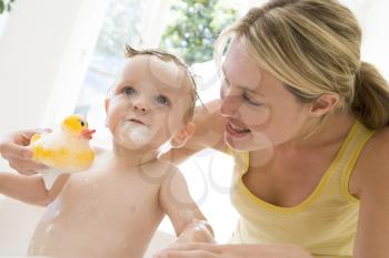 Royalty Free Photo of a Mother Bathing a Baby