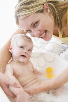 Royalty Free Photo of a Mother Giving a Baby a Bubble Bath