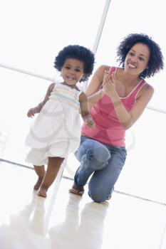 Royalty Free Photo of a Mother and Daughter Playing Indoors