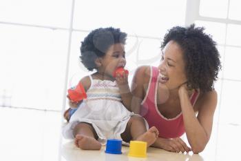 Royalty Free Photo of a Mother and Daughter Playing on the Floor