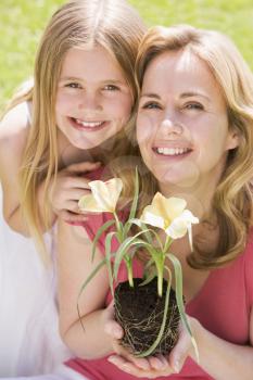 Royalty Free Photo of a Mother and Daughter Holding Flowers