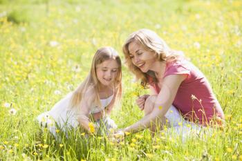 Royalty Free Photo of a Mother and Daughter Picking Flowers