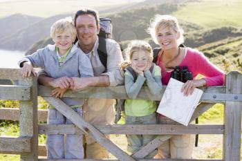 Royalty Free Photo of a Family on a Cliff Leaning on a Fence