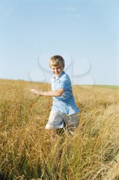 Royalty Free Photo of a Boy Running in a Field