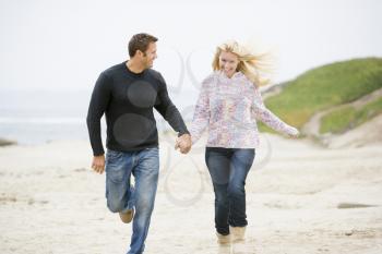 Royalty Free Photo of a Couple Running on the Beach