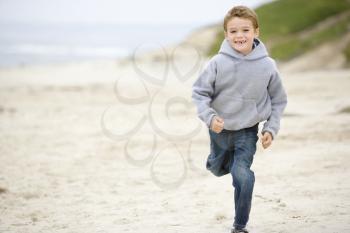 Royalty Free Photo of a Boy Running on the Beach