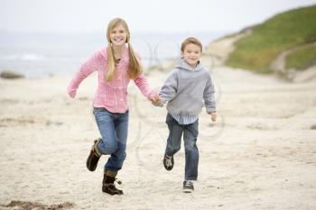 Royalty Free Photo of Two Young Children Running on the Beach
