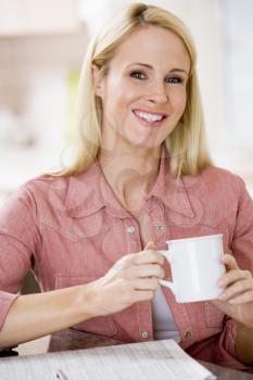 Royalty Free Photo of a Girl With a Coffee and Paper