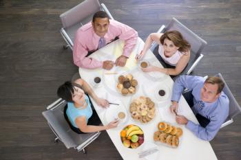 Royalty Free Photo of People in a Boardroom With Food