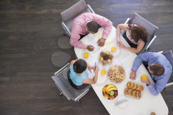 Royalty Free Photo of People in a Boardroom With Breakfast