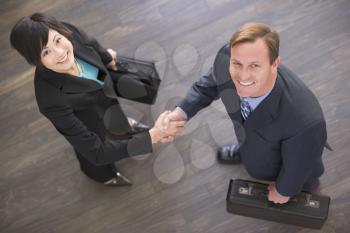 Royalty Free Photo of a Businessman and Woman Shaking Hands