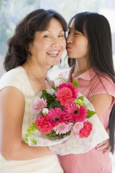 Royalty Free Photo of a Girl Giving Woman Flowers