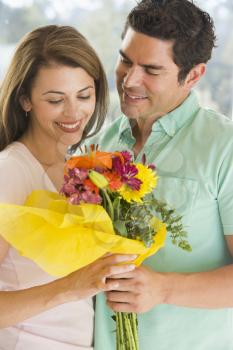 Royalty Free Photo of a Man Giving His Wife Flowers
